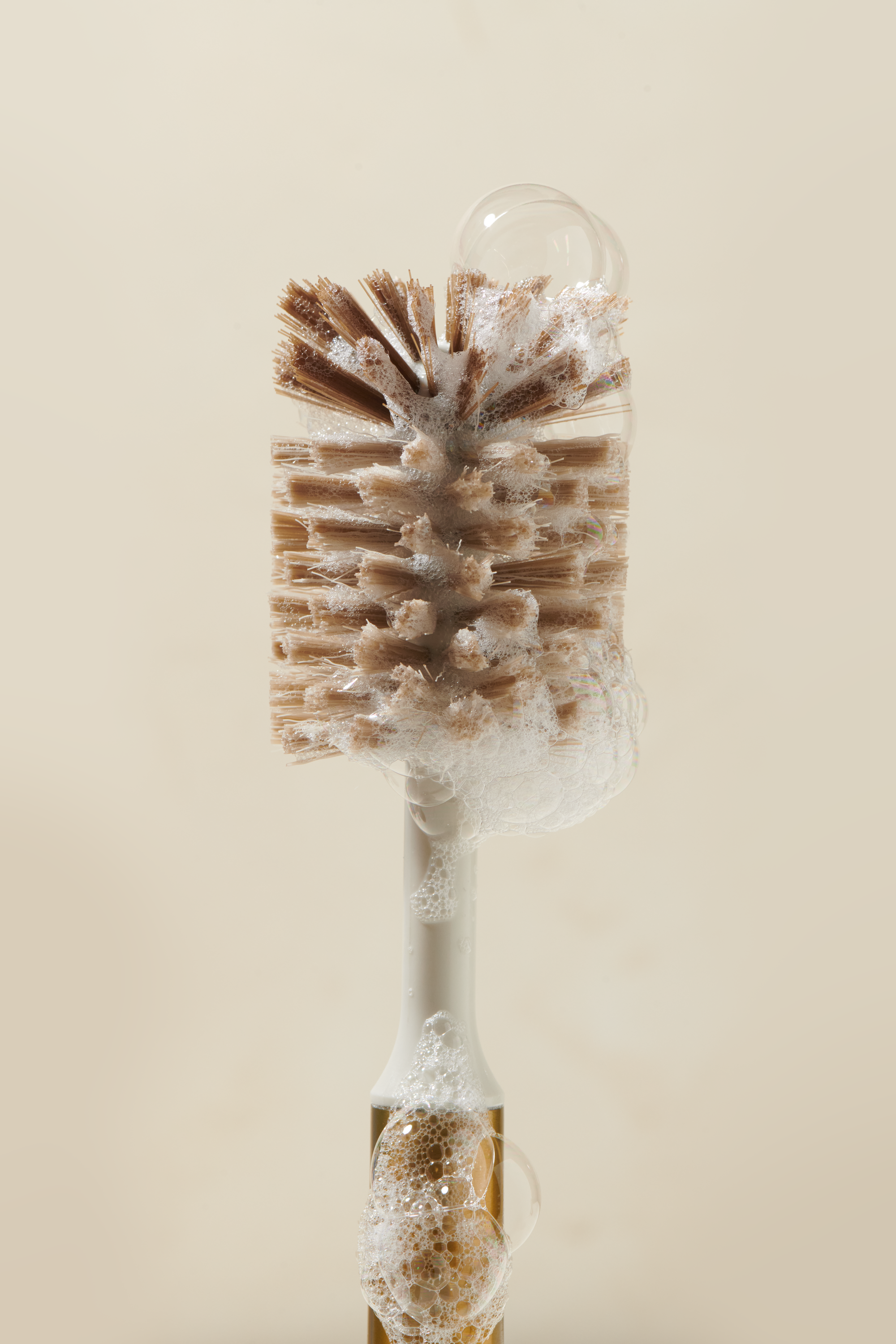 Closeup of Curio Homegoods Brass Ionic Bottle Brush details