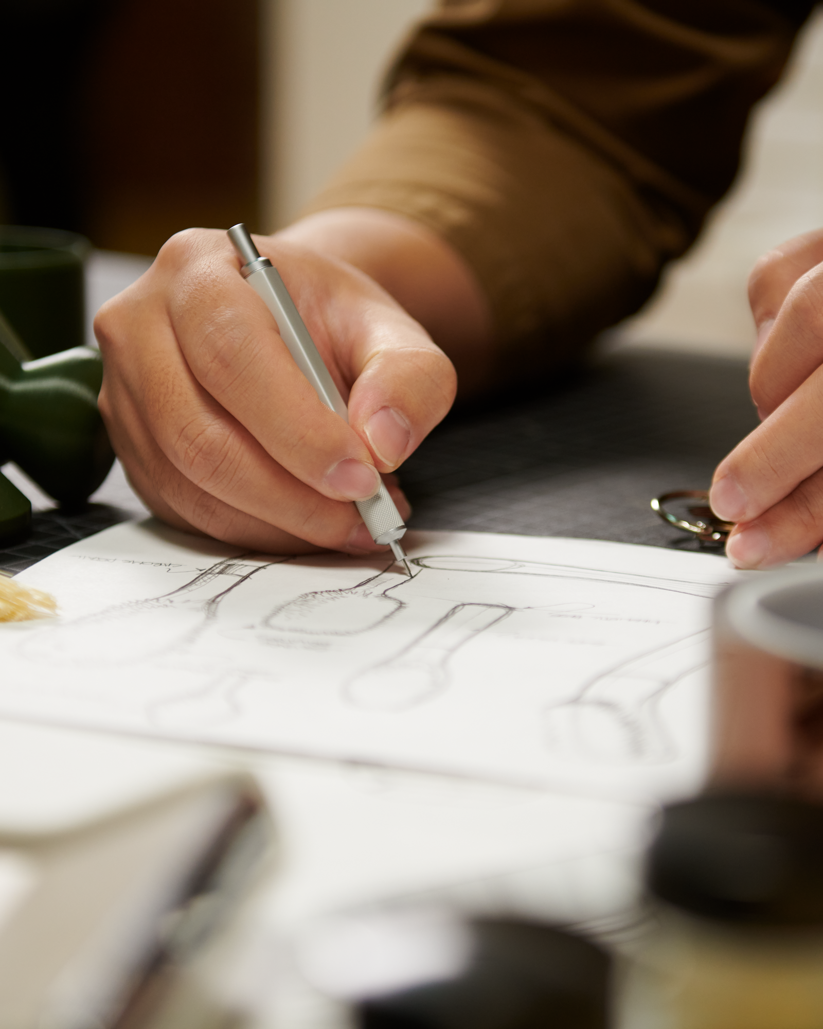 Closeup of Curio Homegoods designer drawing in notebook