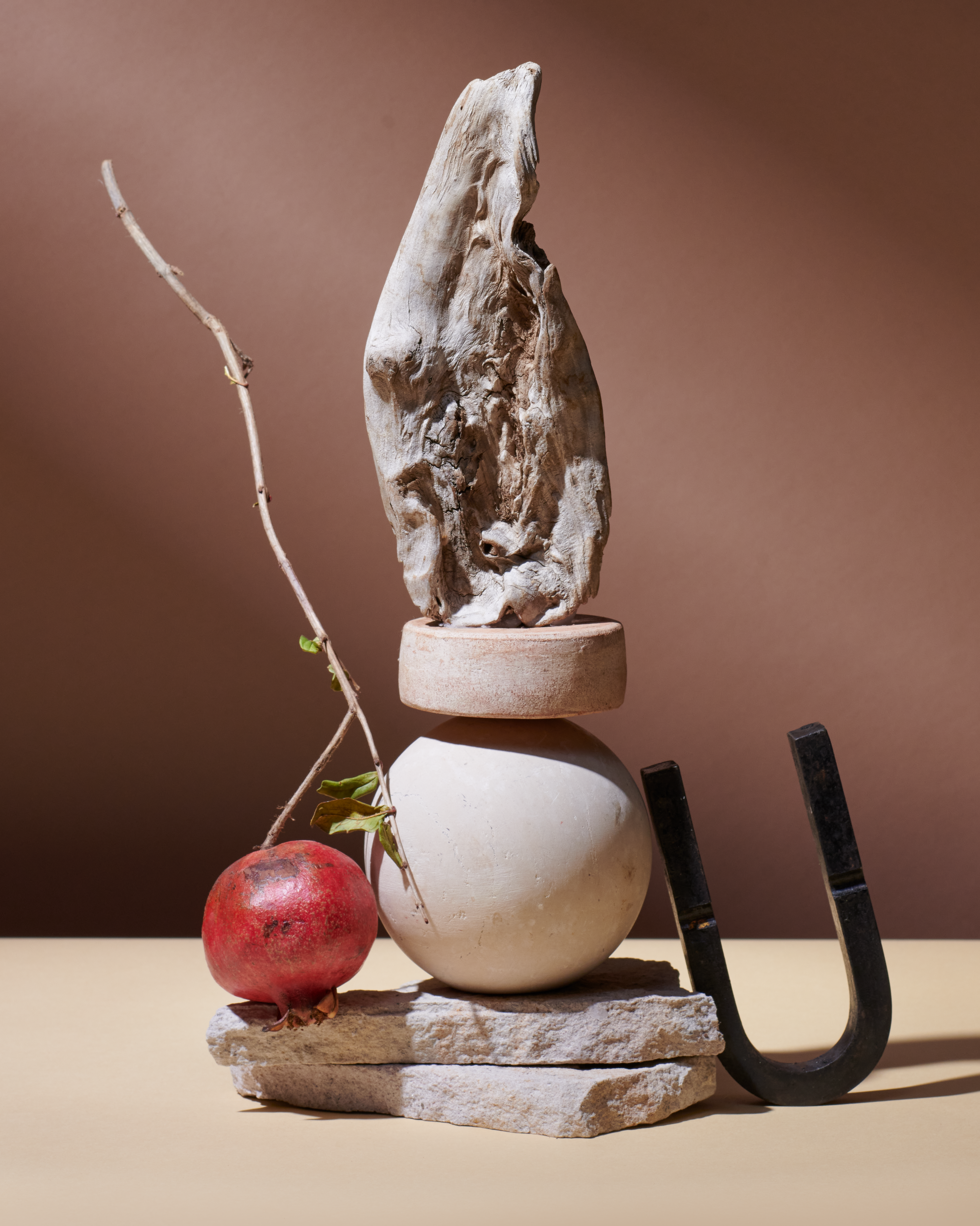Curio Homegoods Ionic Collection among sculptures and fruits
