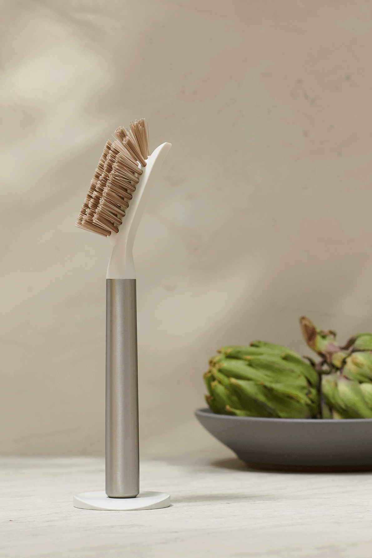 Curio Homegoods Stainless Steel Ionic Dish Brush standing with light background